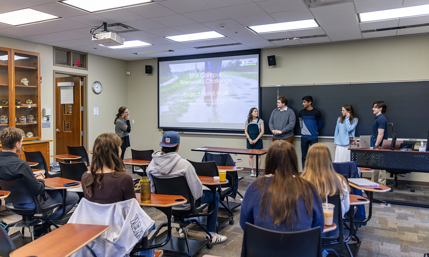 Kinne and students in front of classroom