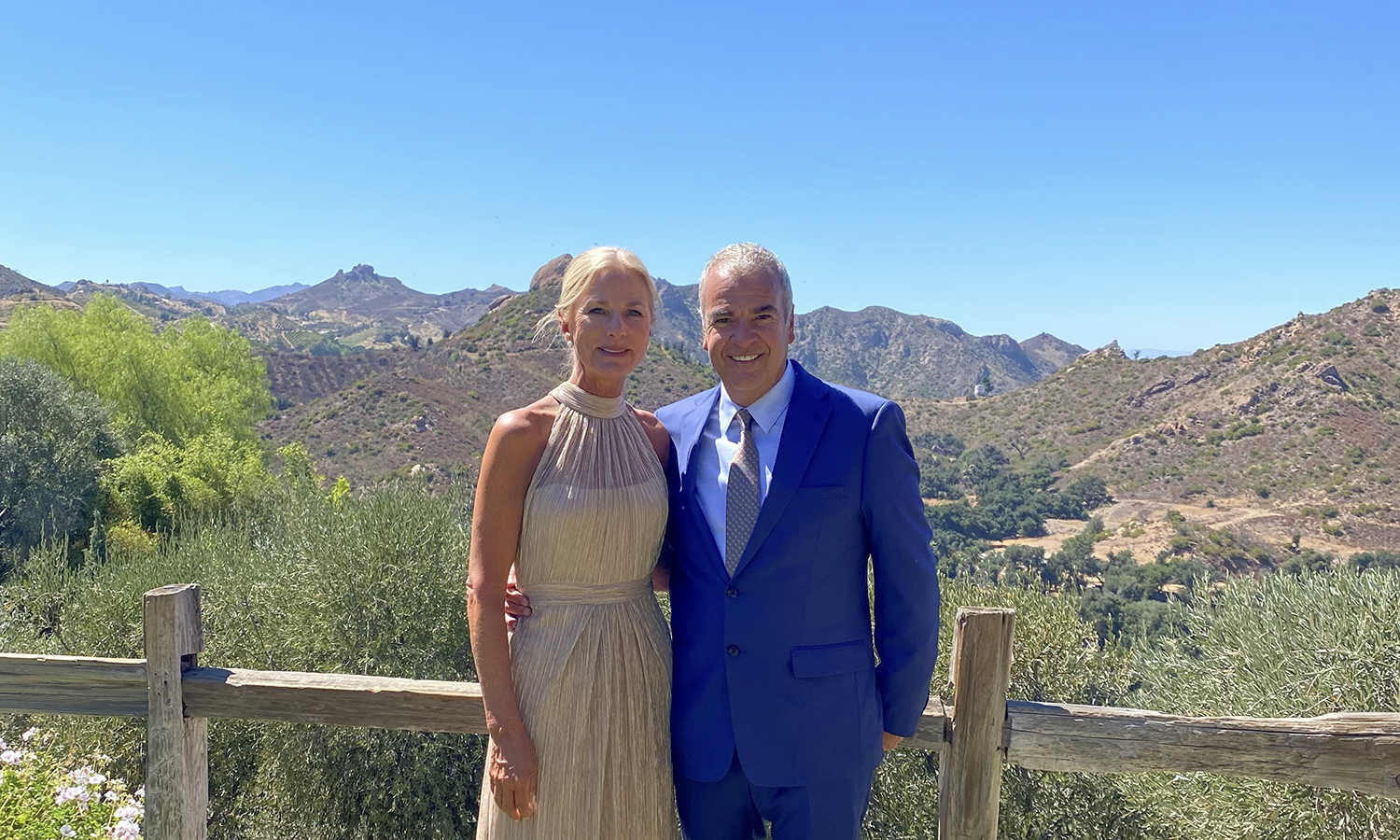 pam and joe longo pose in front of view for a photo