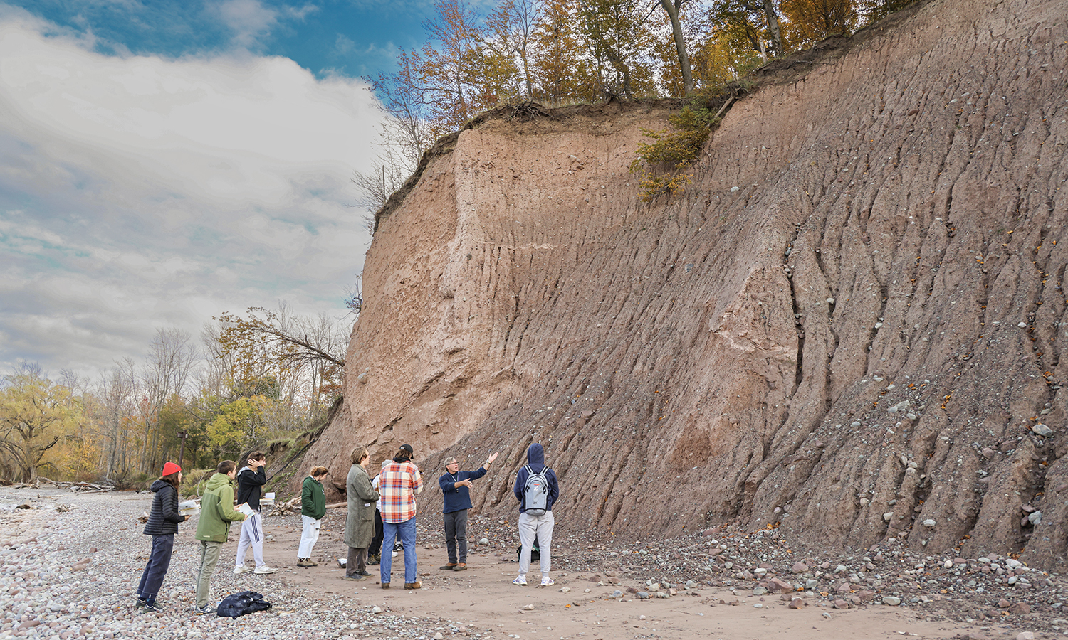Students in “Introduction to Geology” talk with Associate Professor of Geoscience David Kendrick during a visit to Chimney Bluffs State Park on Lake Ontario.
