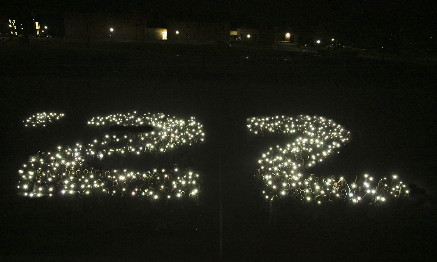 On the eve of Commencement, we look back at memorable moments from the Classes of 2022's four years on campus. Here, students gather for an illumination photo during Orientation.