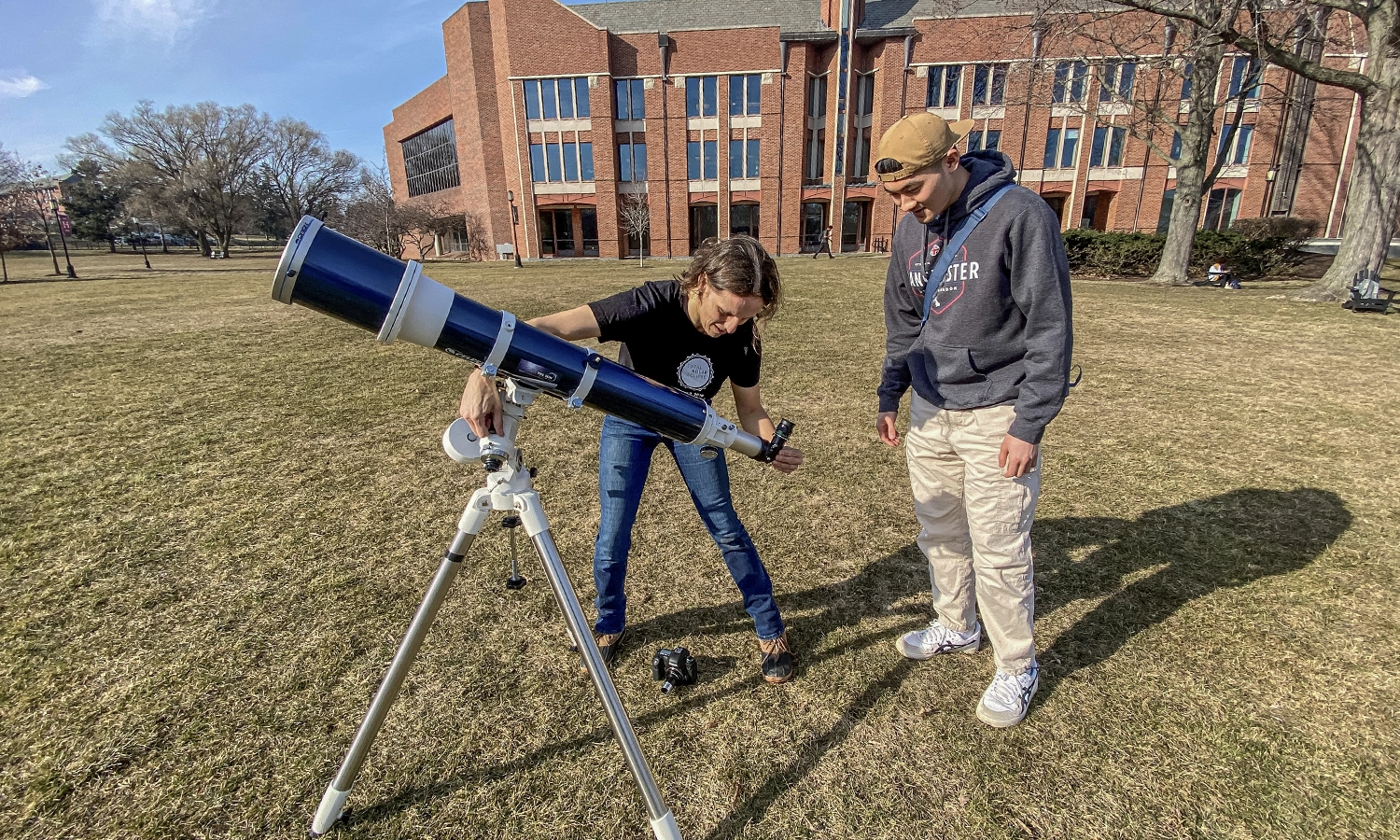 In anticipation of the Total Solar Eclipse, Associate Professor of Physics Leslie Hebb tests her telescope to examine sunspots with Andy Dinh '27.