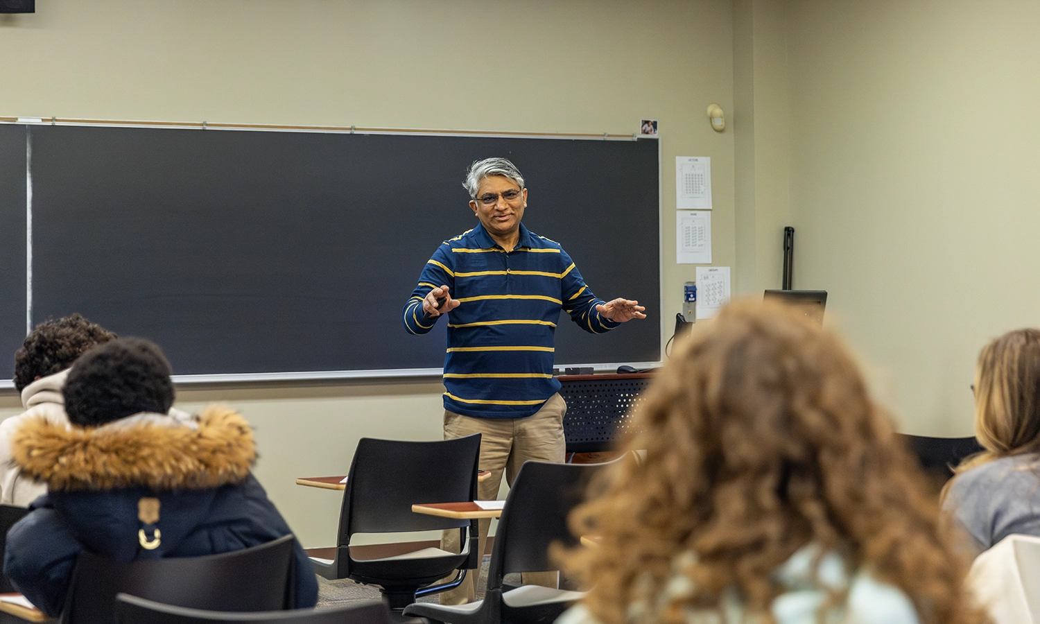 Professor of Economics Feisal Khan leads a class discussion in Stern Hall.