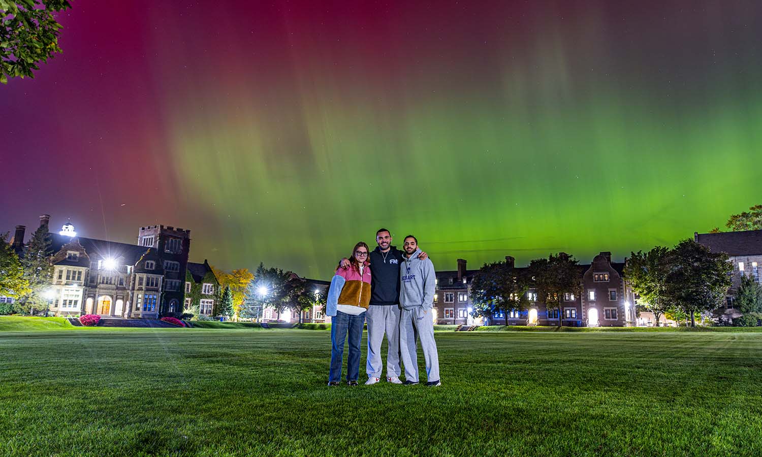 Barbora Mickute ’27, Mohammad Yassin ’25 and Hussein Labib ’25 pose for a photo on the Quad under an incredible showing of the Northern Lights.