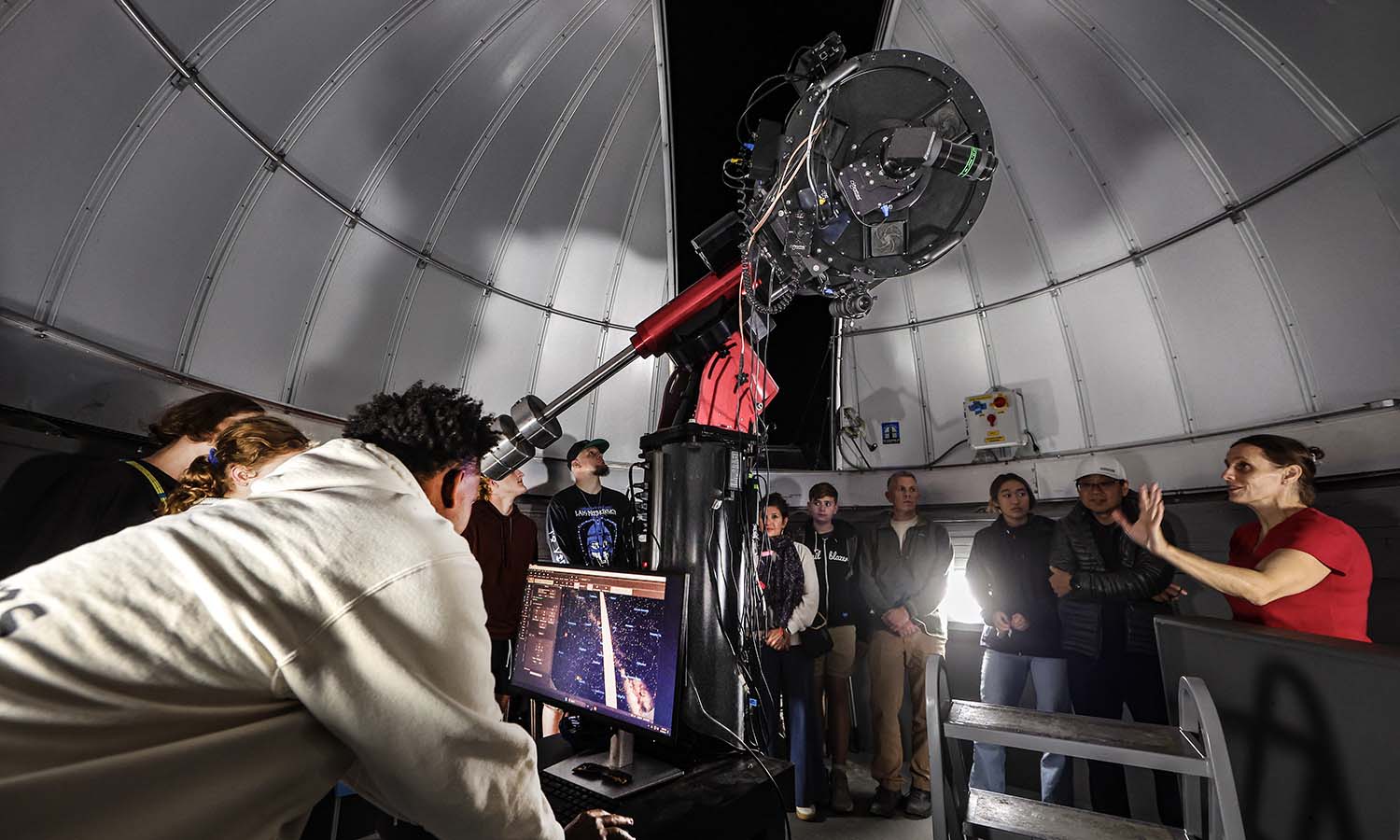 During Homecoming and Family Weekend, Associate Professor of Physics Leslie Hebb speaks to students and their families at the Richard S. Perkin Observatory open house.