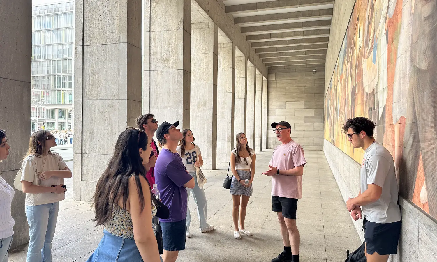 Students studying abroad in Germany with Associate Professor of Management and Entrepreneurship Craig Talmage visit a mural in Leipzig.