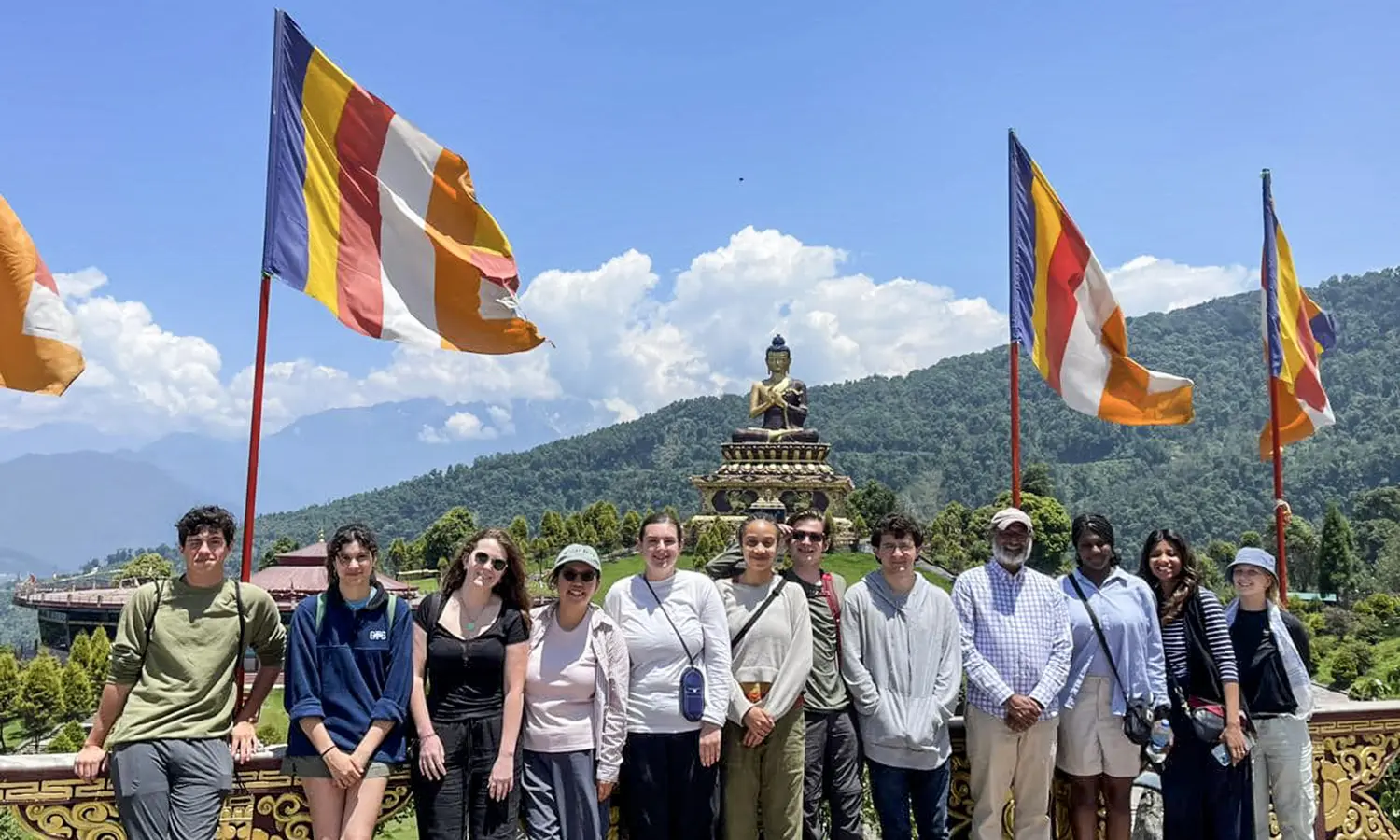 In Sikkim, India, students and Associate Professor of International Relations Vikash Yadav pose at Buddha Park in Ravangla.