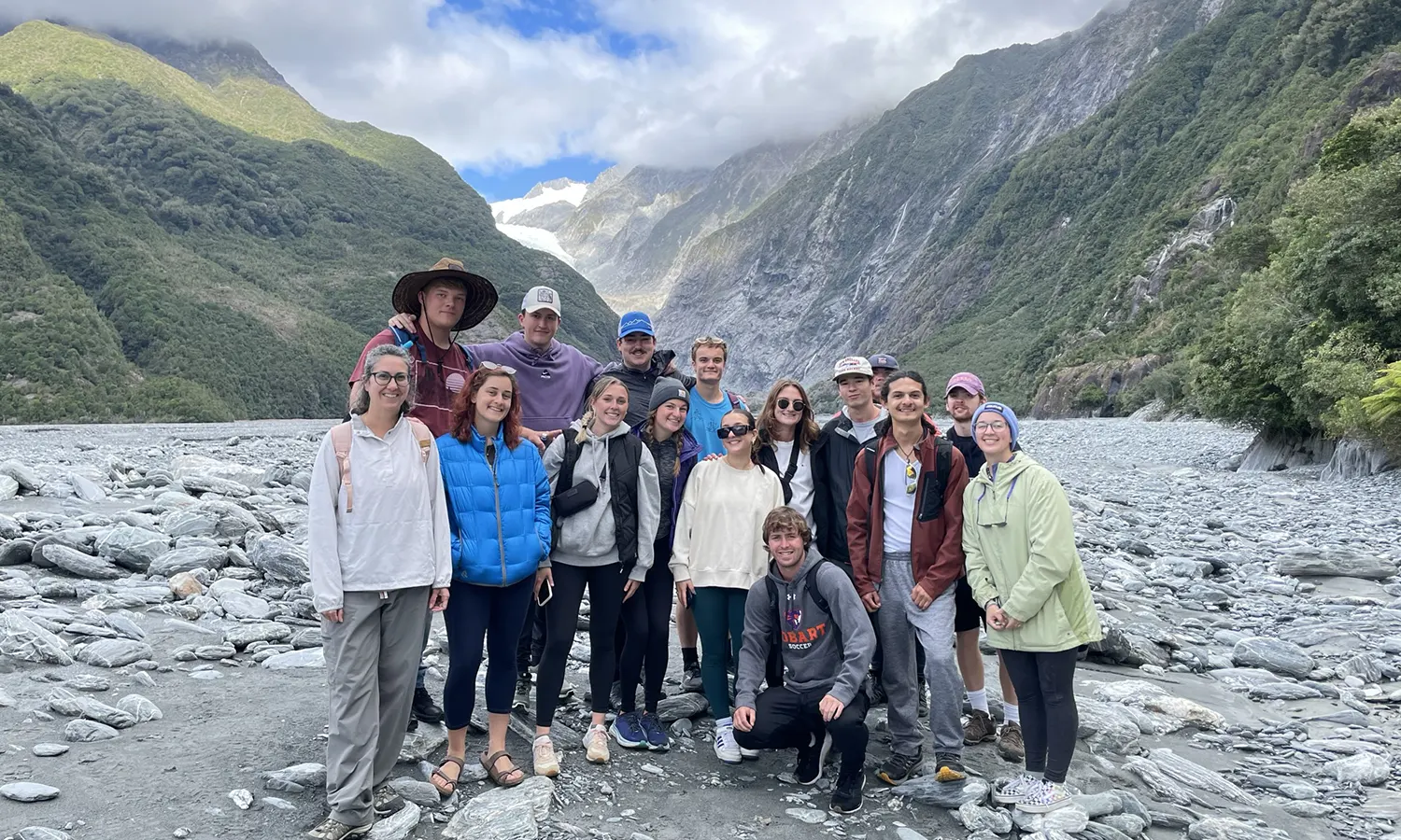 In New Zealand, students studying abroad with Associate Professor of Environmental Studies Whitney Mauer take a group photo at the South Island of Aotearoa.