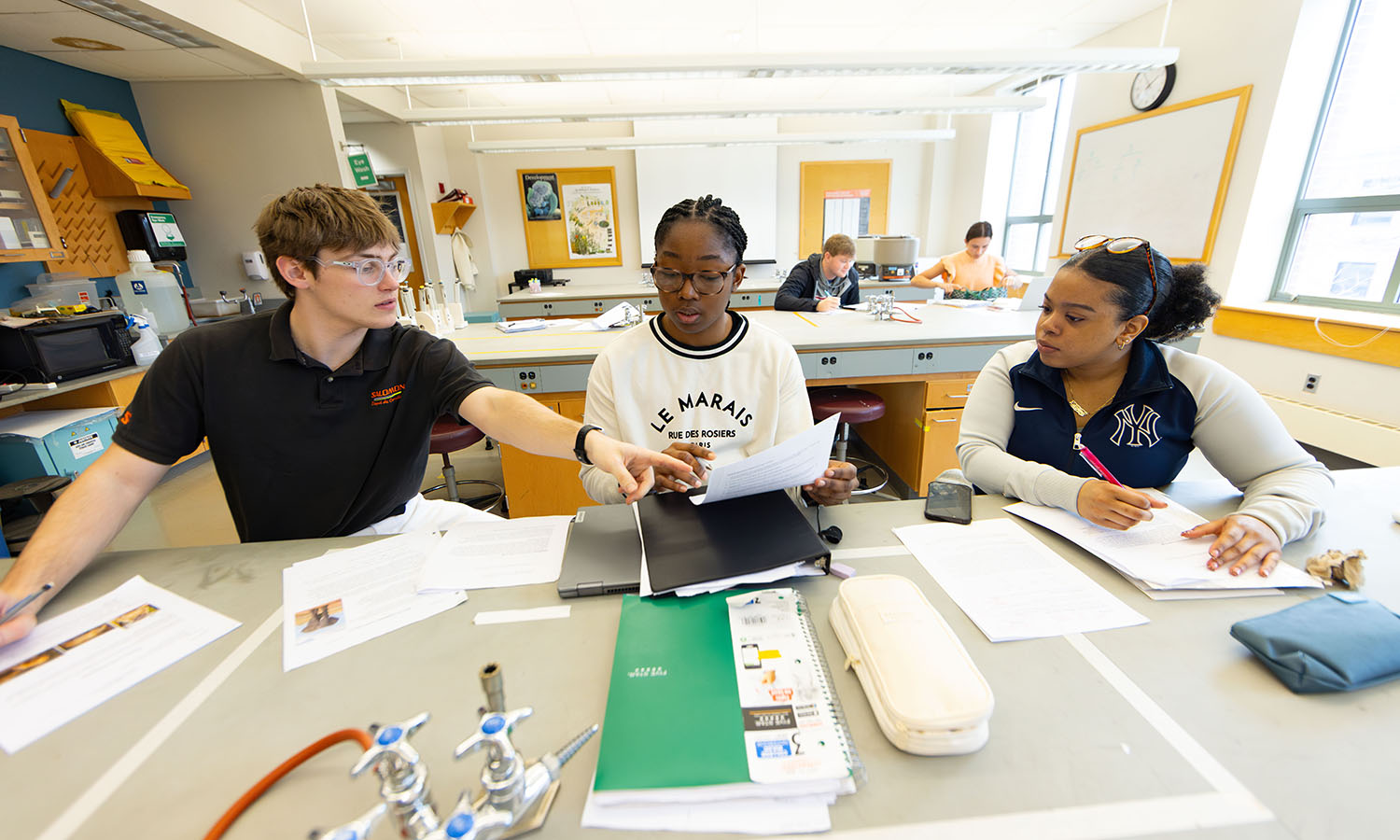 Wil Ozanne '28, Faith Okoli '26 and Zulenny Reyes '26 work together on an apoptosis experiment in