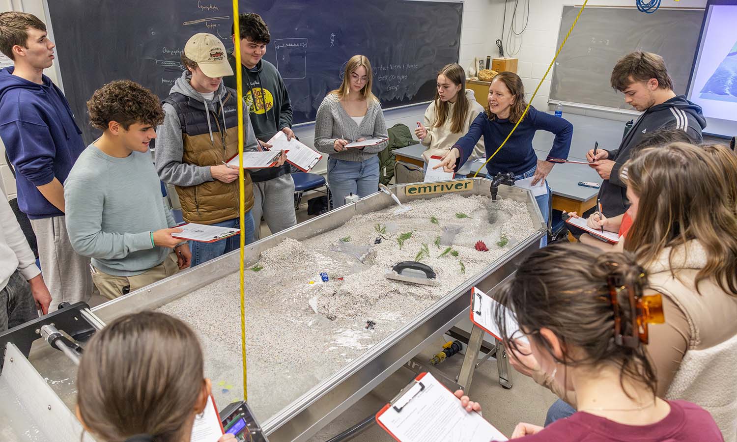 Associate Professor of Geoscience Tara Curtin leads students through a lab using a stream table to simulate the effects of long-term erosion during “Introduction to Hydrogeology.”