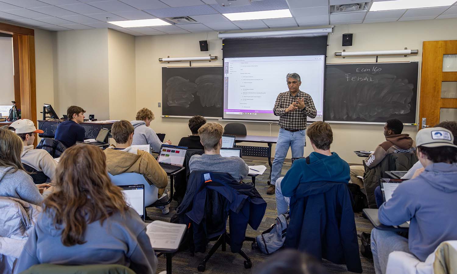 Professor of Economics Feisal Khan introduces a new lesson during “Principles of Economics” in Stern Hall.