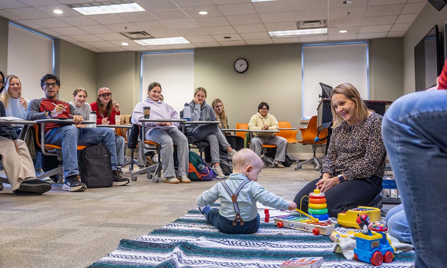 Students in Professor of Psychological Science Julie Kingery's “Introduction to Child Psychology” participate in a “guess the age” activity with a special visitor.