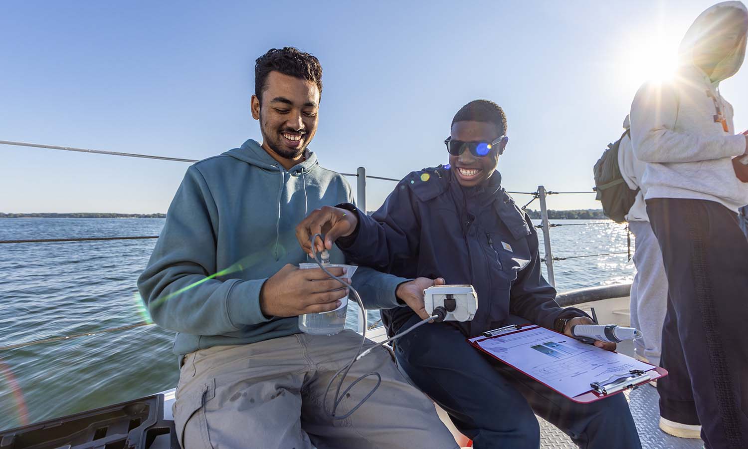 While aboard the William Scandling Research Vessel during “Parched” with Associate Professor of Geoscience Tara Curtin, Jubayer Ansary ’29 and Nigel Presume ’29 measure the pH and total dissolved solids in water sampled from Seneca Lake.