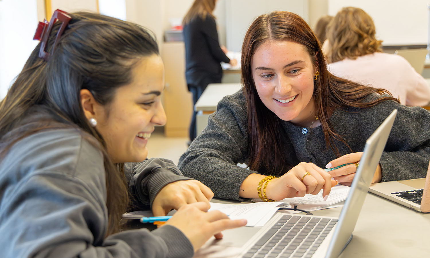 Ava Lobozzo ’27 and Grace O'Connor '27 review a computer simulation during Associate Professor of Biology Shannon Straub’s “Evolution” lab.