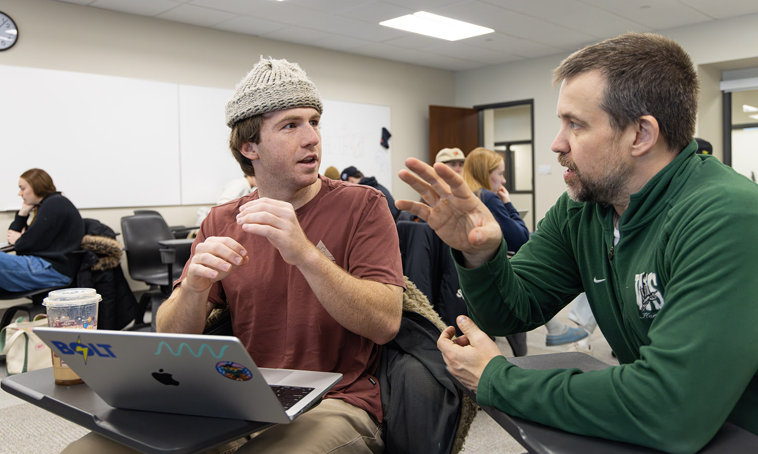 Cooper Delbridge ’26 discusses a statistical model for his team’s interactive dashboard project with Professor of Mathematics & Computer Science Jonathan Forde during their Data Analytics Capstone.