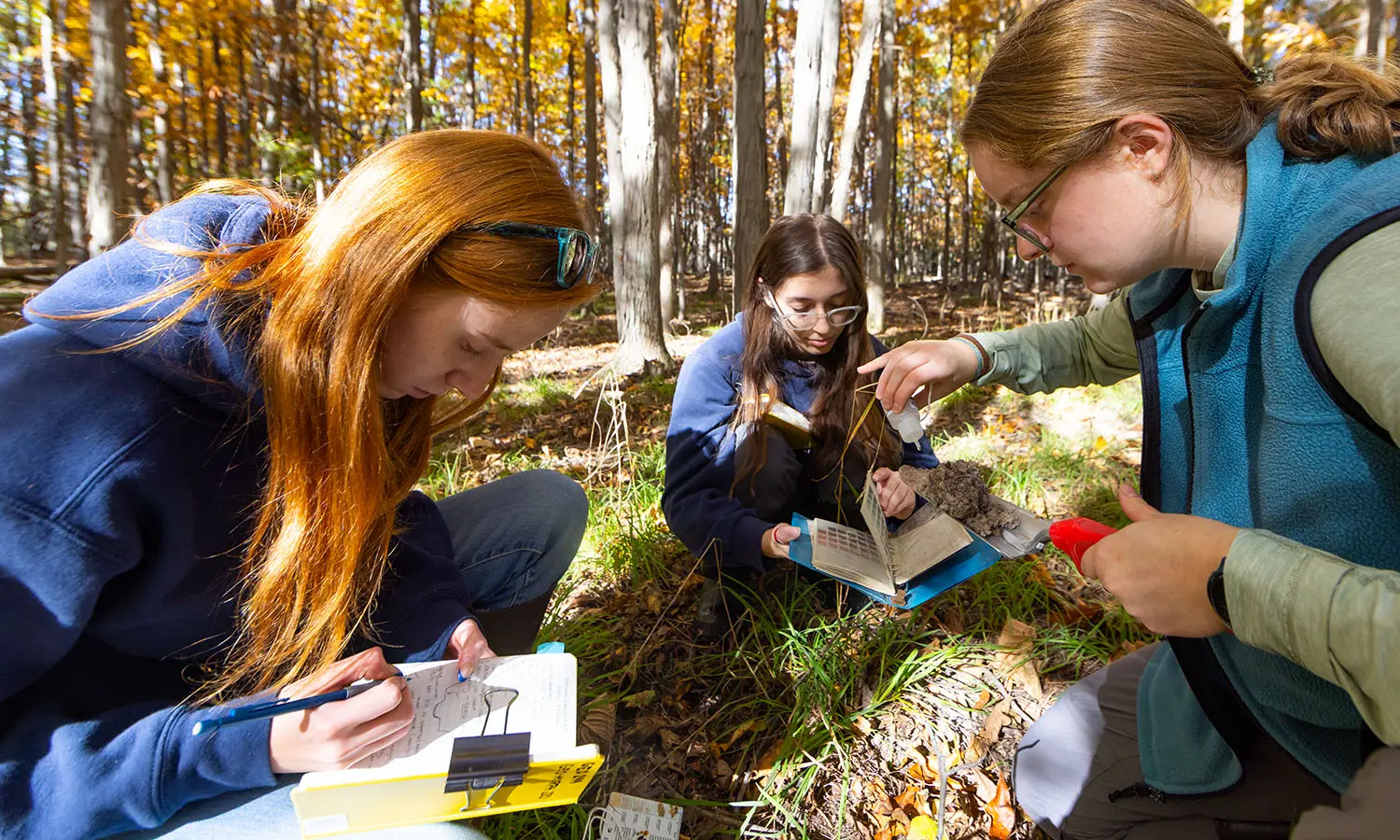 Demi Mouillesseaux ’28, Angela Ciccone ’28 and Elizabeth Molisaniin ’28 analyze sediment from former floodplains to build hypotheses linking climate change to historic stream incision in Coopers’ Woods during