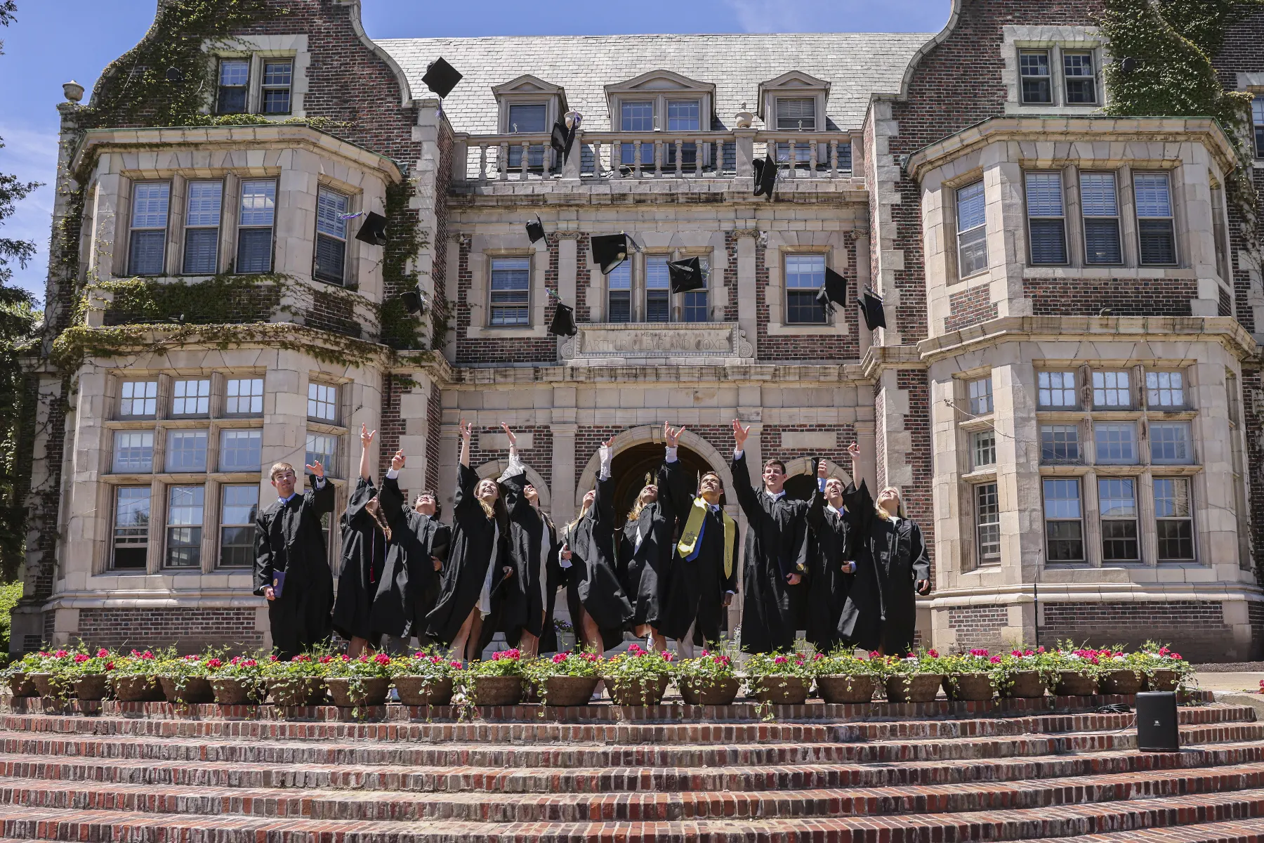 Students throw caps in the air after graduation