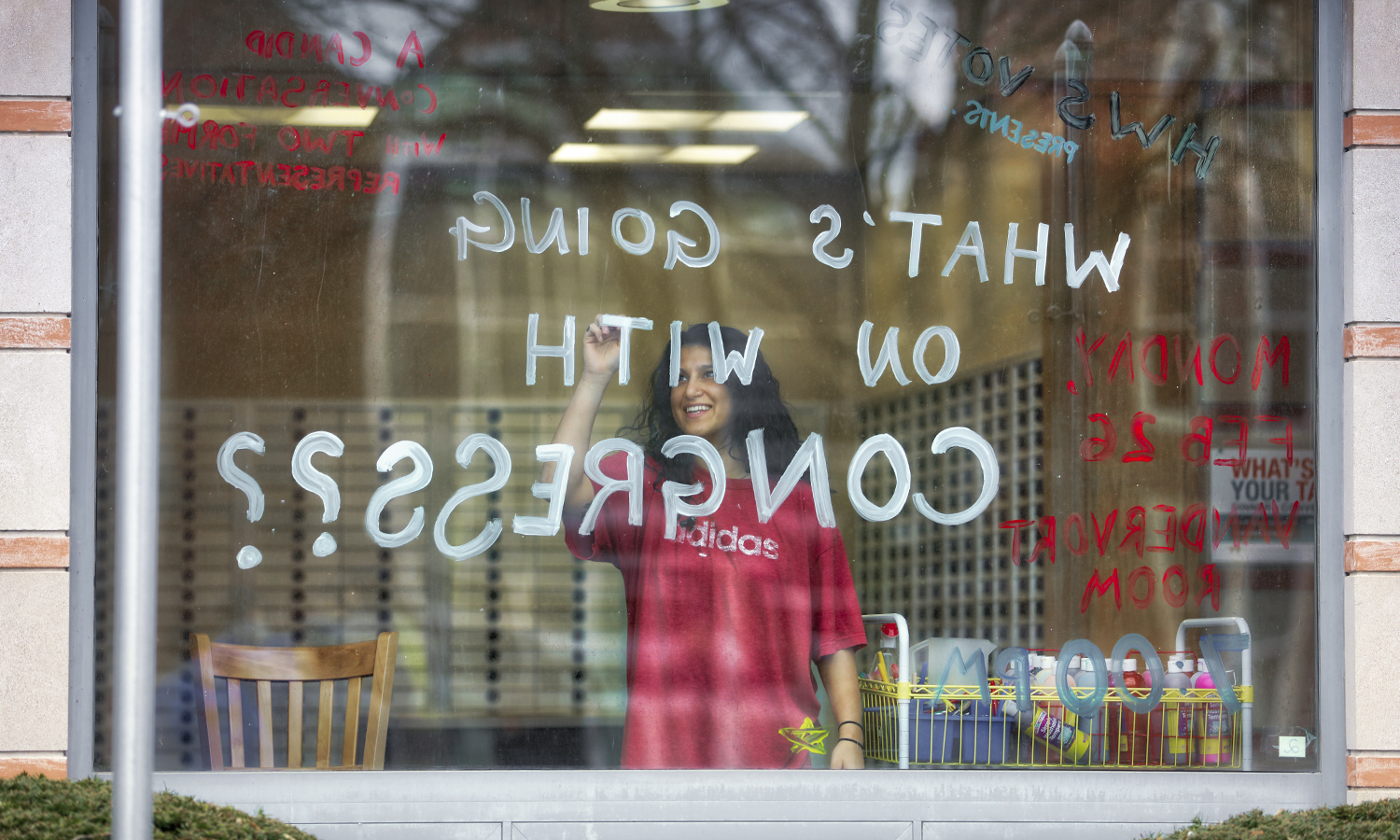 Student writes on a window