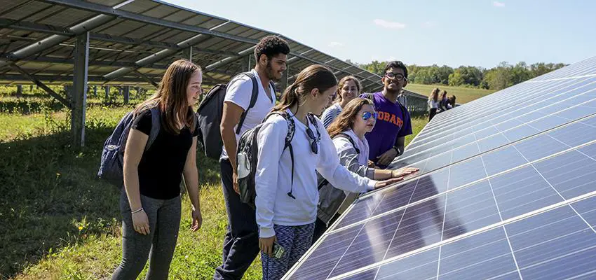 Students study the solars panels at the HWS Gates Rd. solar farm