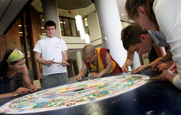 Professor Tenzin Yignyen constructing a sand mandala with students in 2009.